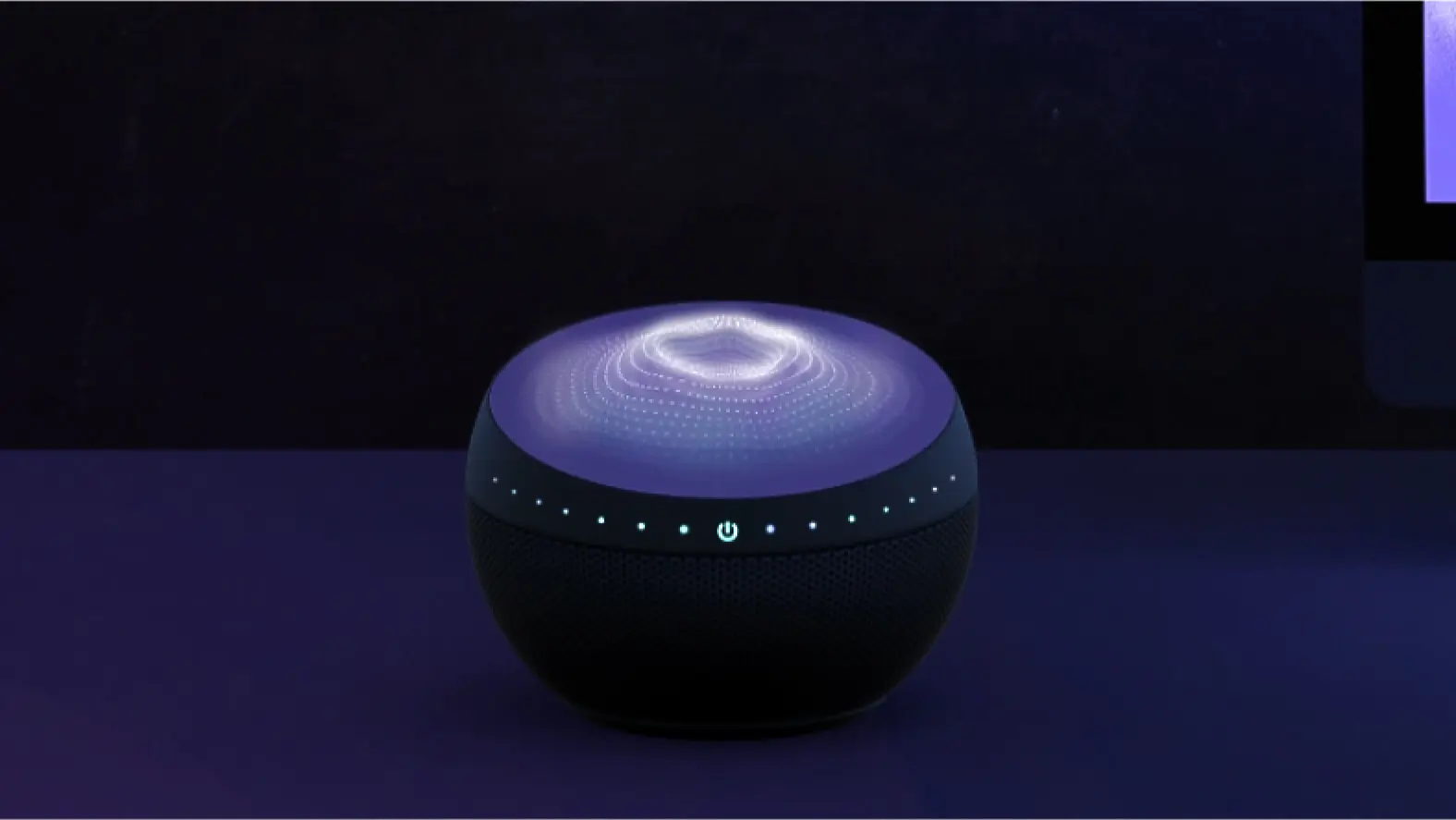 a computer monitor and a speaker on a desk